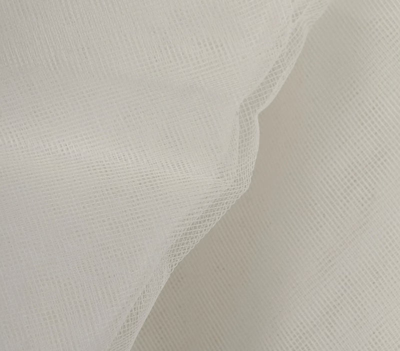 Close-up of textured white fabric on a light gray background