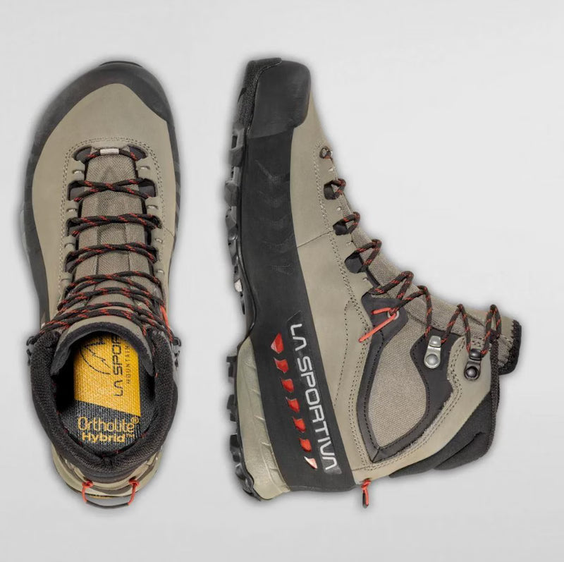 Pair of hiking boots with visible brand logo on a light gray background