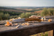 Knife with wooden handle on a wooden surface with a scenic background