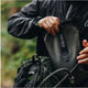 Person holding a black Hydro Flask water bottle outdoors