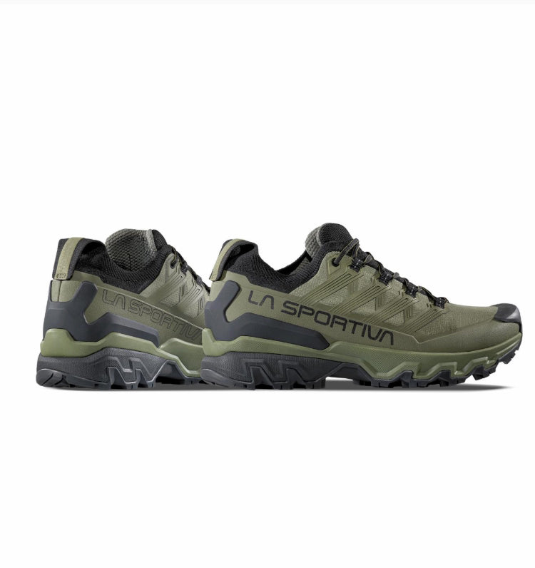 Pair of green hiking shoes with black accents on a white background