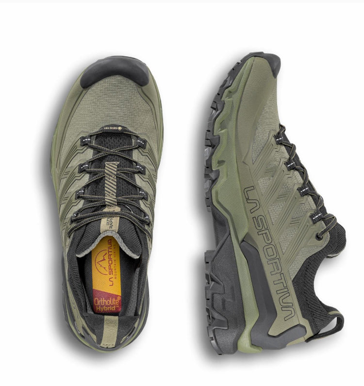 Green hiking shoes with black soles on a white background