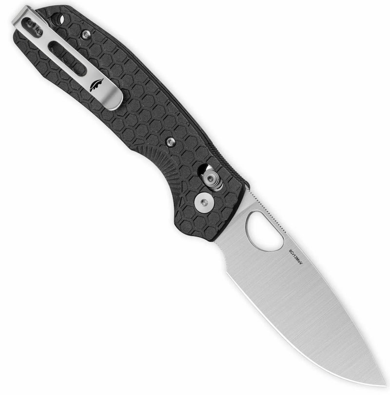 Folding knife with black handle and silver blade on a white background