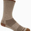 A single mid-calf sock shown in profile against a plain white background. The sock is primarily a heathered taupe-brown color with darker brown textured knit panels on the lower leg and heel, and a matching brown toe cap.