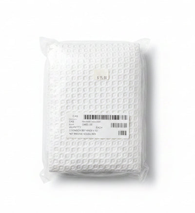 A white textured pillowcase folded and sealed in a clear plastic bag, with a white shipping label and barcode on a plain white background.