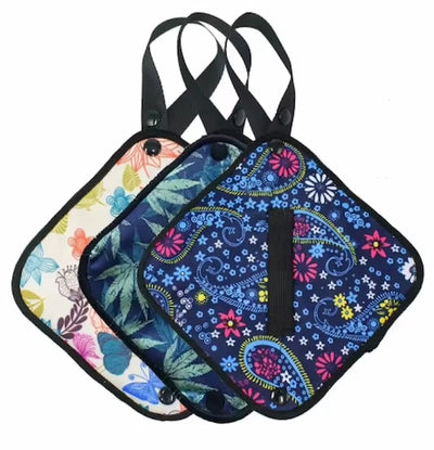 Three colorful patterned bags with straps on a white background