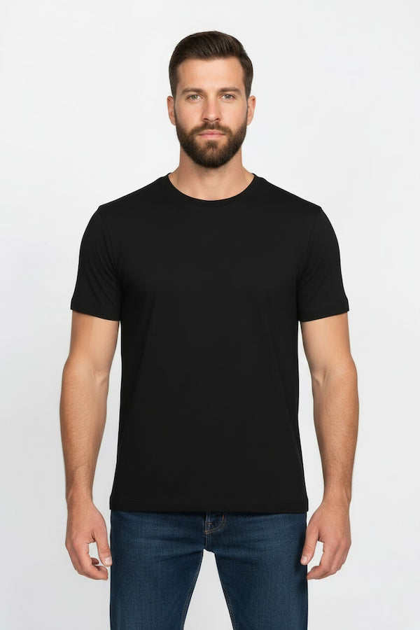 Man wearing a black t-shirt and blue jeans on a white background