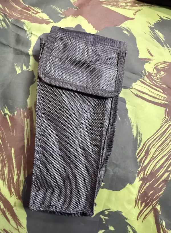 Black mesh pouch on a camouflage-patterned background
