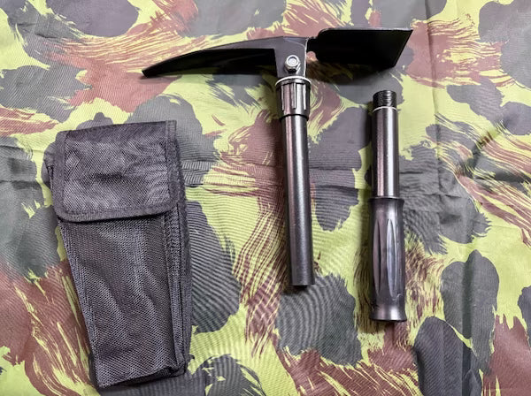 Two tools, one with a pouch, on a camouflage-patterned surface