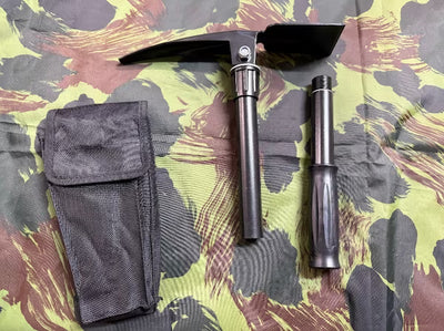 Two tools, one with a pouch, on a camouflage-patterned surface