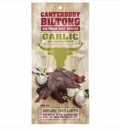 Canterbury Biltong Garlic and Cracked Pepper snack packaging on a wooden background