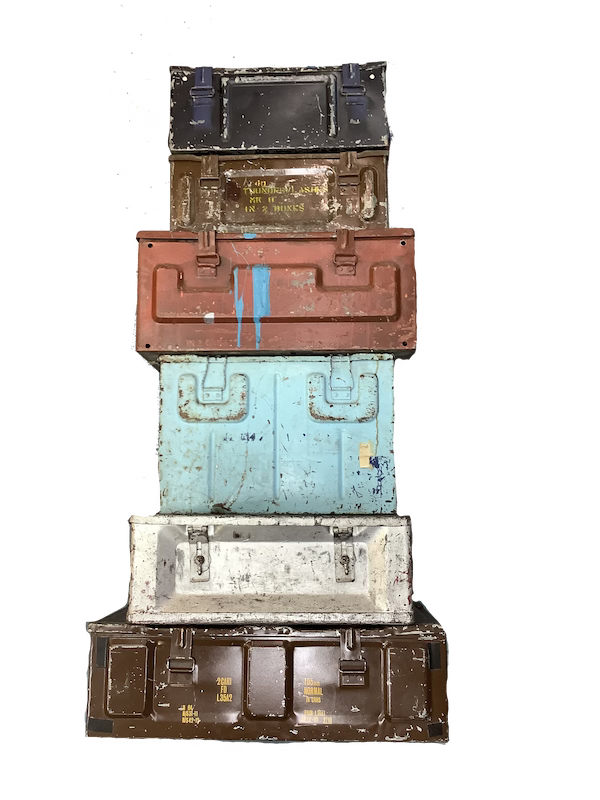 Stack of vintage suitcases with different colors and textures on a white background