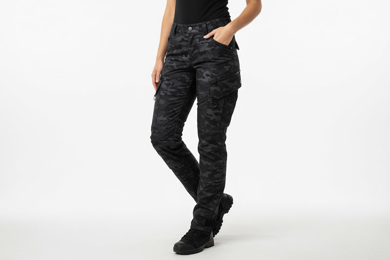 Person wearing black camouflage pants on a white background