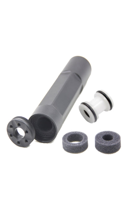 An airsoft suppressor with barrel spacer and additional parts, primarily in black color.