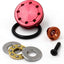 An image of an aluminium piston head for airsoft guns, displayed alongside its components such as seals and a washer. The piston head has a red metallic finish.